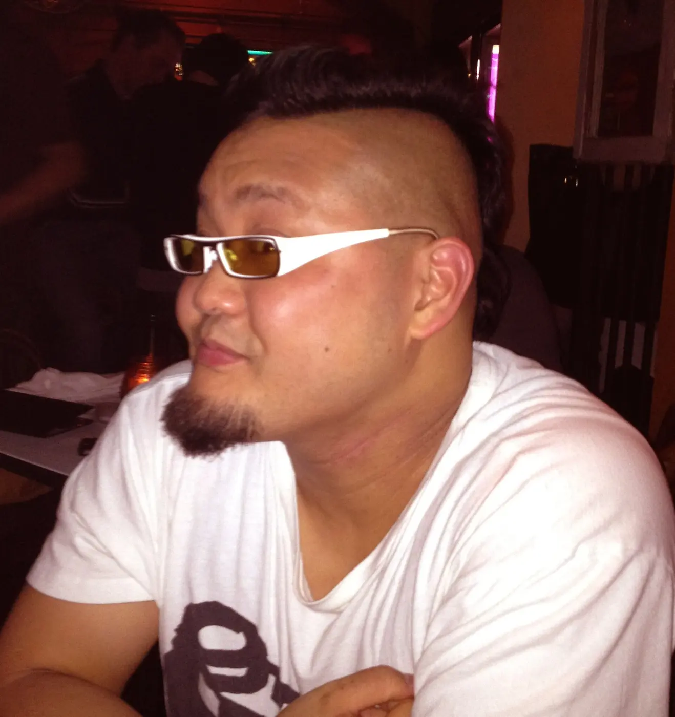 Profile of a man wearing sunglasses, his face and neck flushed red