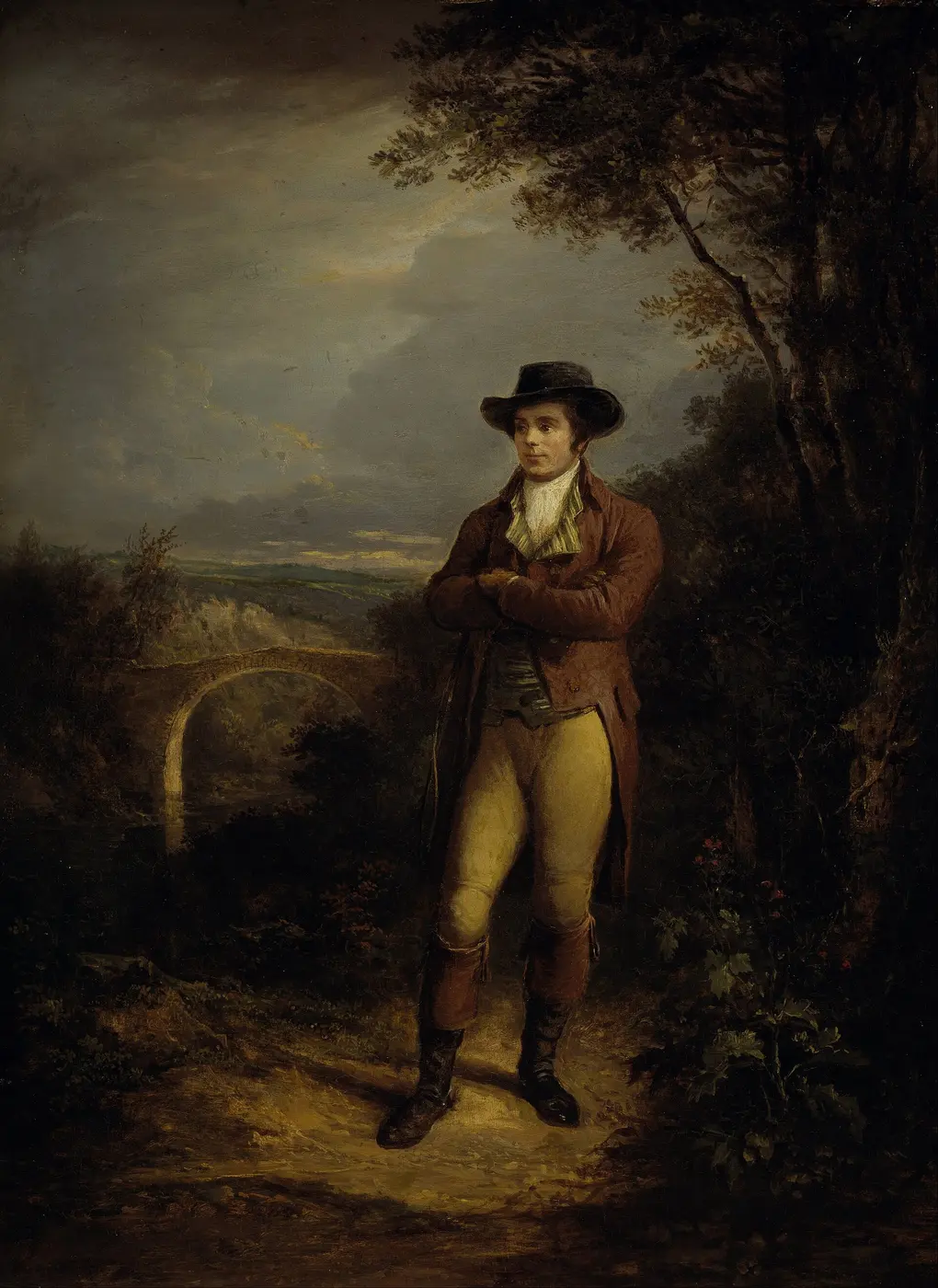 An oil painting of a young man in a hat standing with his arms folded among trees