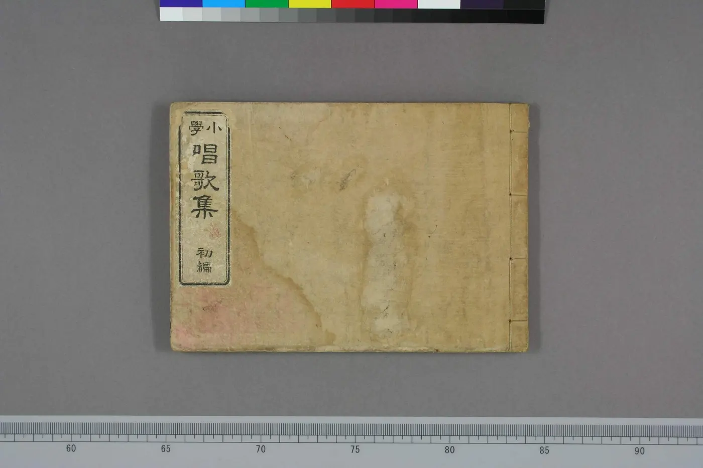 An old Japanese stitch-bound book whose cover label reads “Shōgaku Shōka-shū, Volume 1”