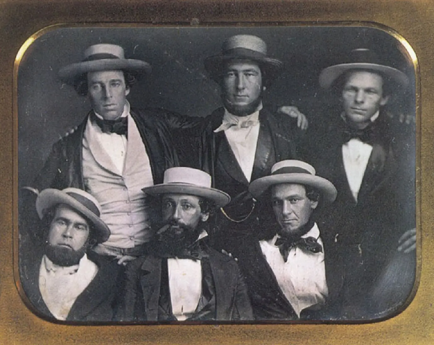 An old photograph of six men in wide-brimmed hats, jackets and neckties
