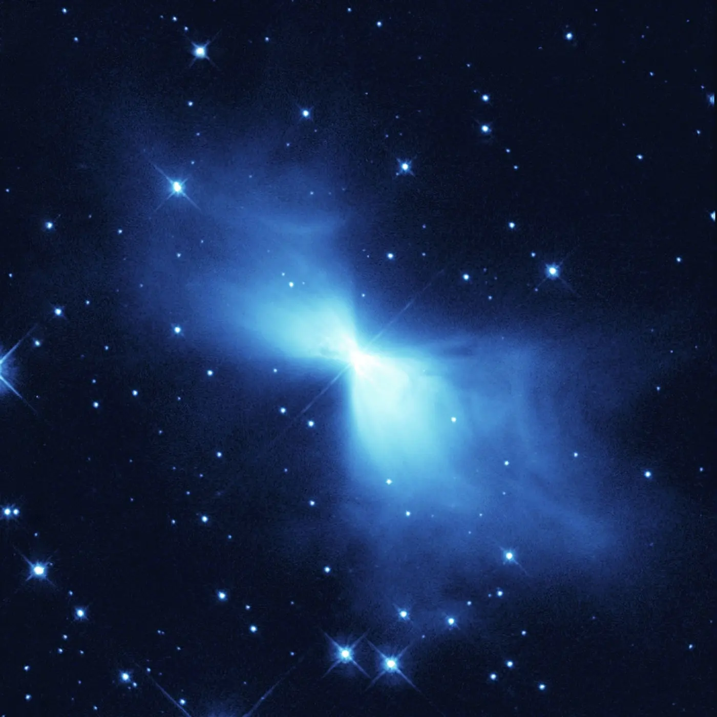 A nebula of pale blue glowing gas spreading left and right from a bright center like butterfly wings
