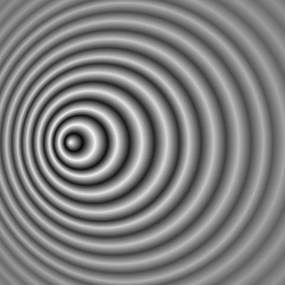 Concentric waves spreading from a center, closely spaced on the left and widely spaced on the right