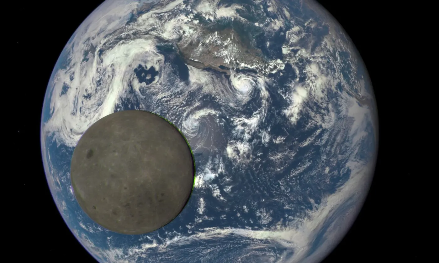 A sunlit gray Moon passing in front of a blue Earth swirling with clouds