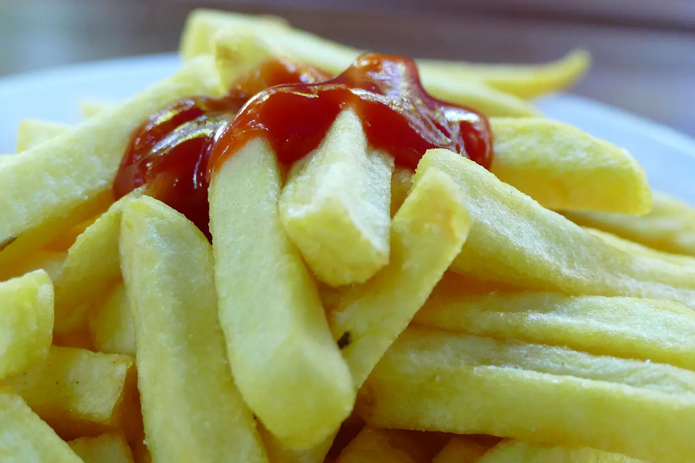 Red tomato ketchup on a plate of french fries