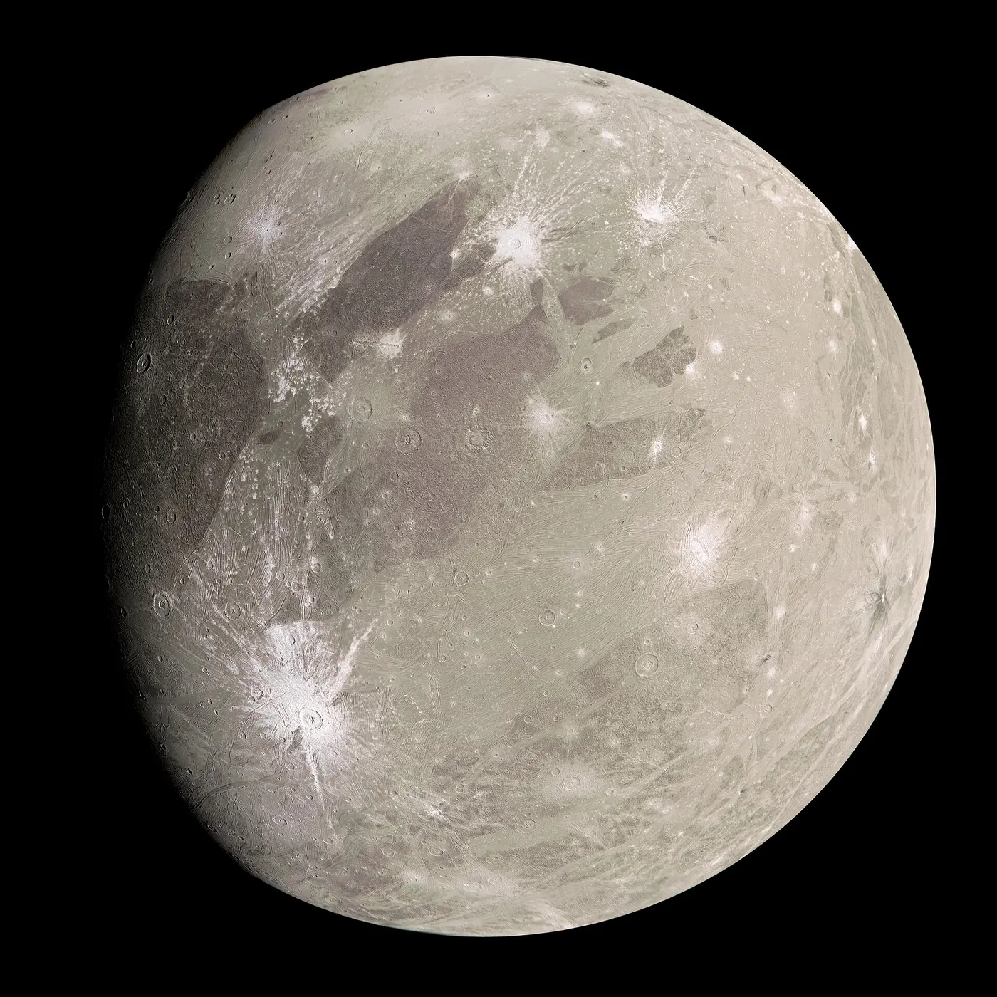 A round body with a mottled gray-and-brown surface scattered with white streaks and bright craters