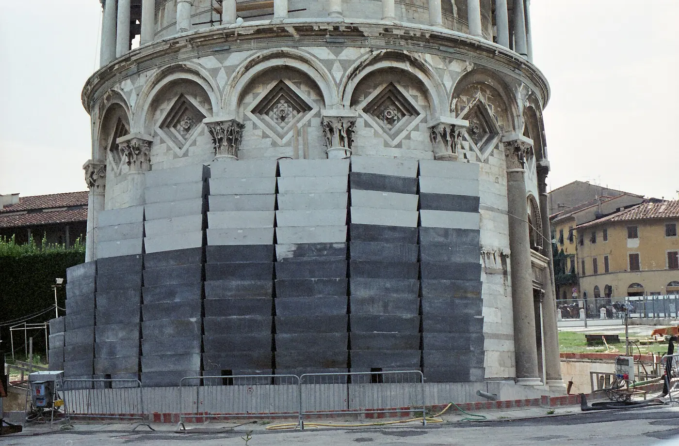 Dark blocks of lead stacked around the base of the Leaning Tower