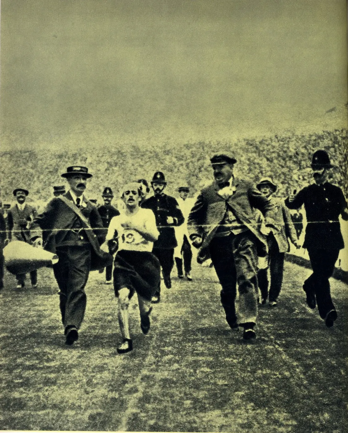 Dorando Pietri heading for the finish, accompanied by officials, in the 1908 London Olympic marathon