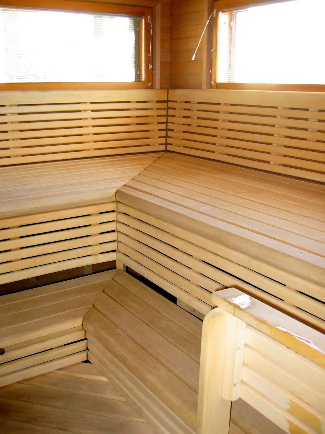 Inside a Finnish sauna, with tiered benches made of wooden slats