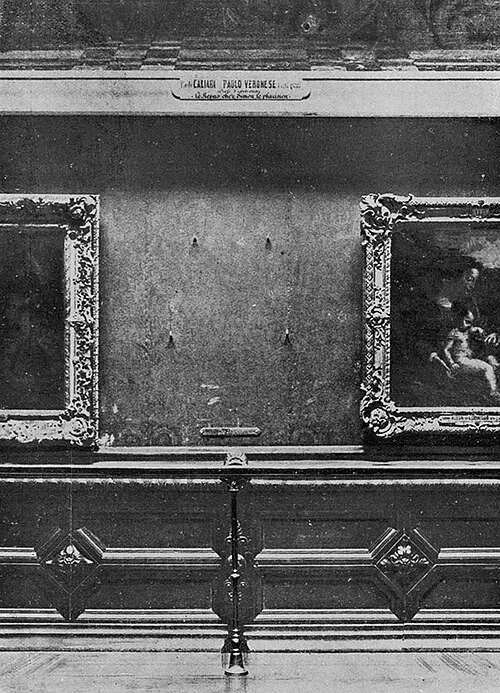 A black-and-white photo of a gallery wall lined with framed paintings, with an empty space where one is missing