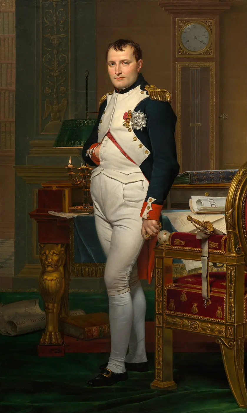 A full-length portrait of Napoleon standing beside the desk in his study, his right hand tucked into his jacket