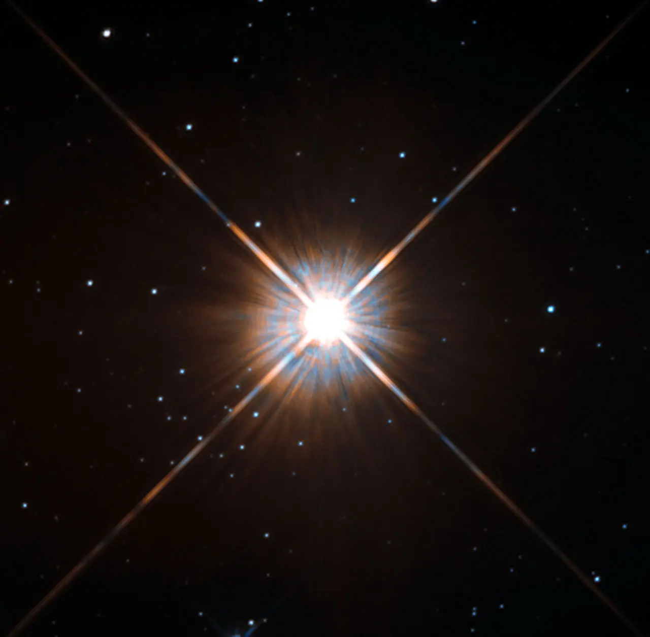 A bright star with cross-shaped spikes of light at the center of a black background