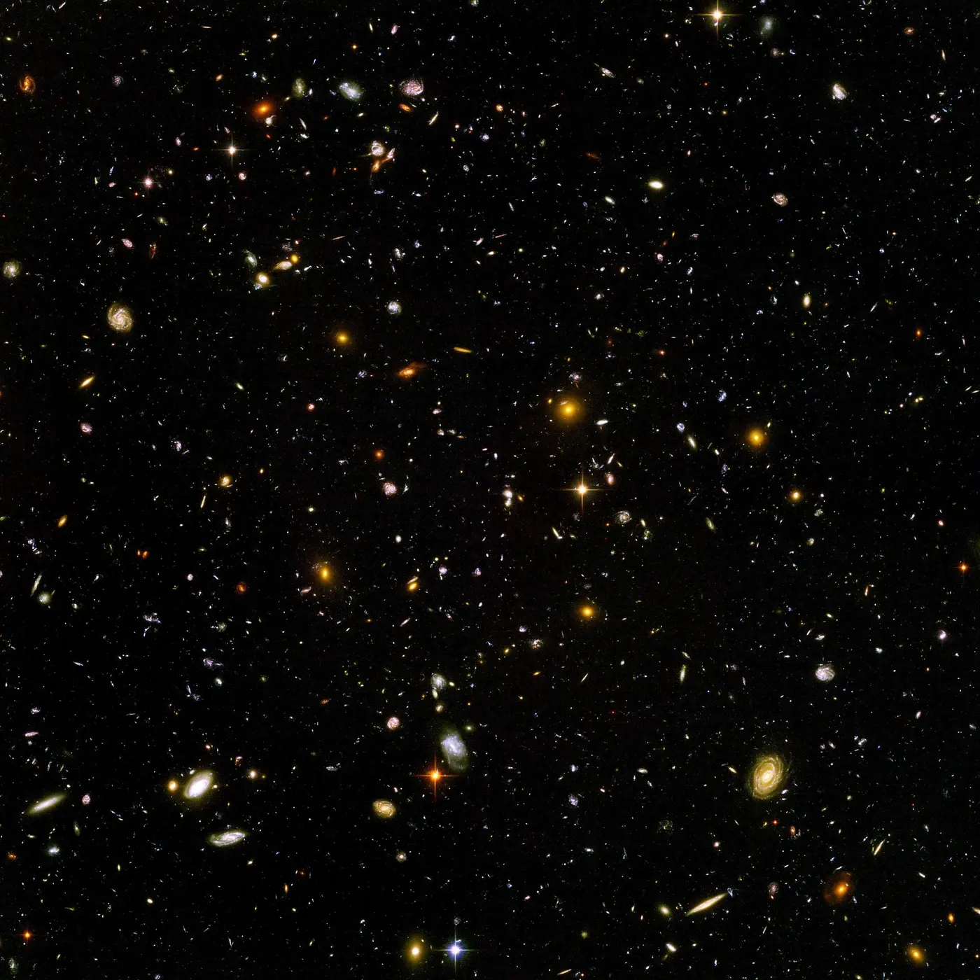 Countless small galaxies of every color and shape scattered across a black background