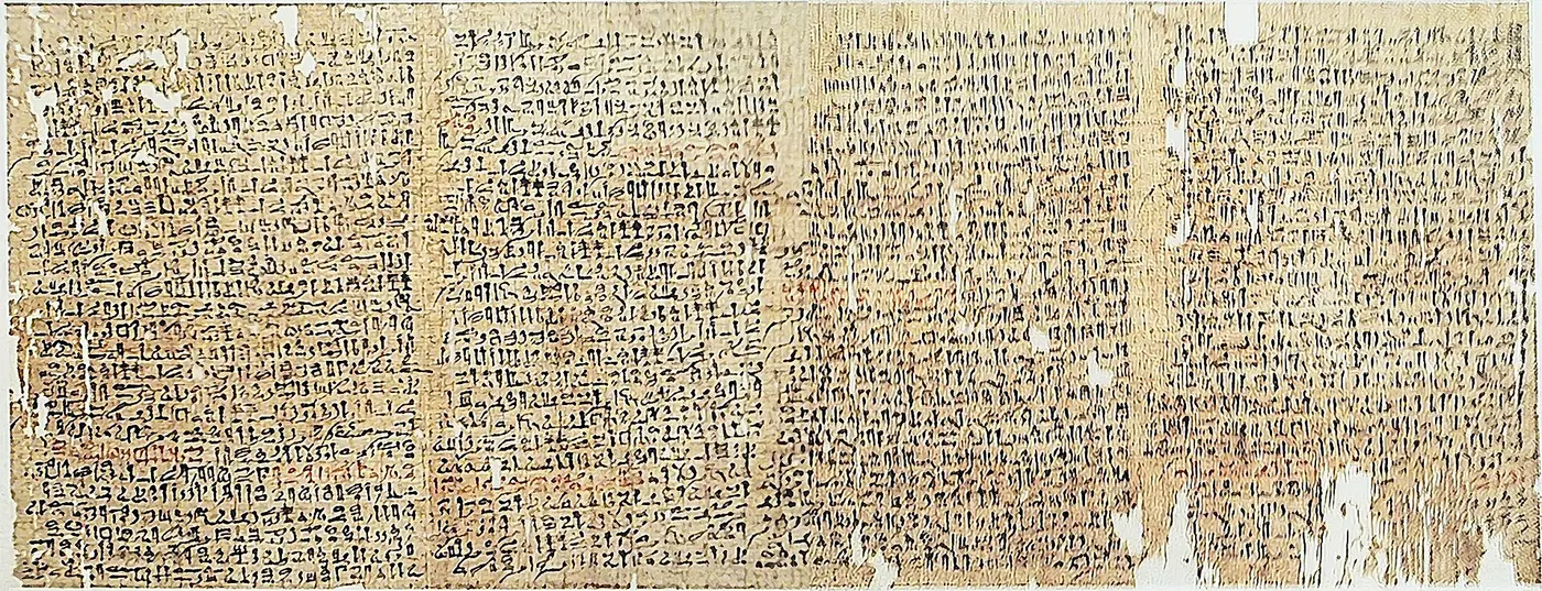 A long papyrus covered in rows of ancient Egyptian writing in black and red ink