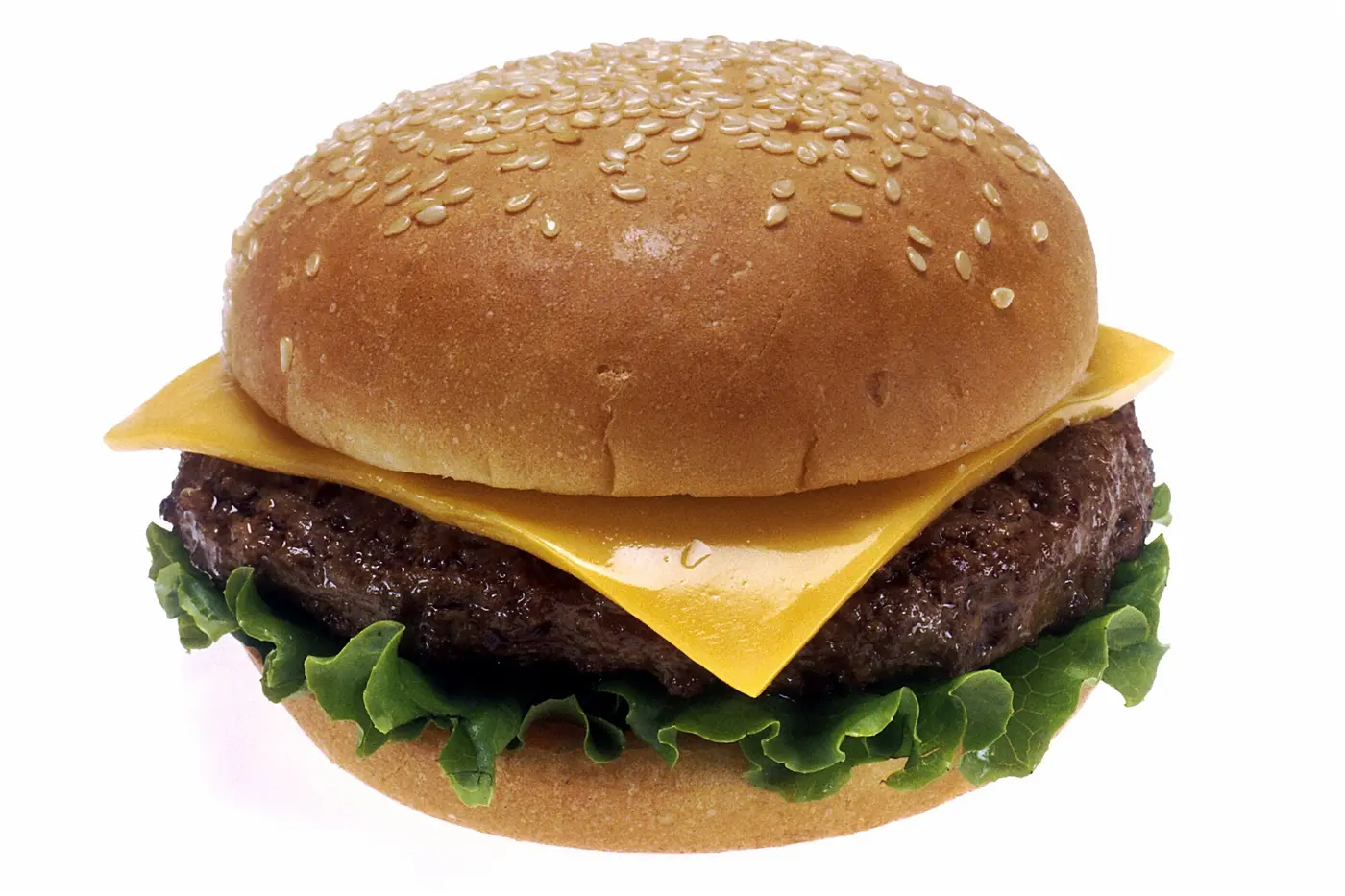 A cheeseburger: a sesame-seed bun holding a grilled meat patty, melted cheese and lettuce