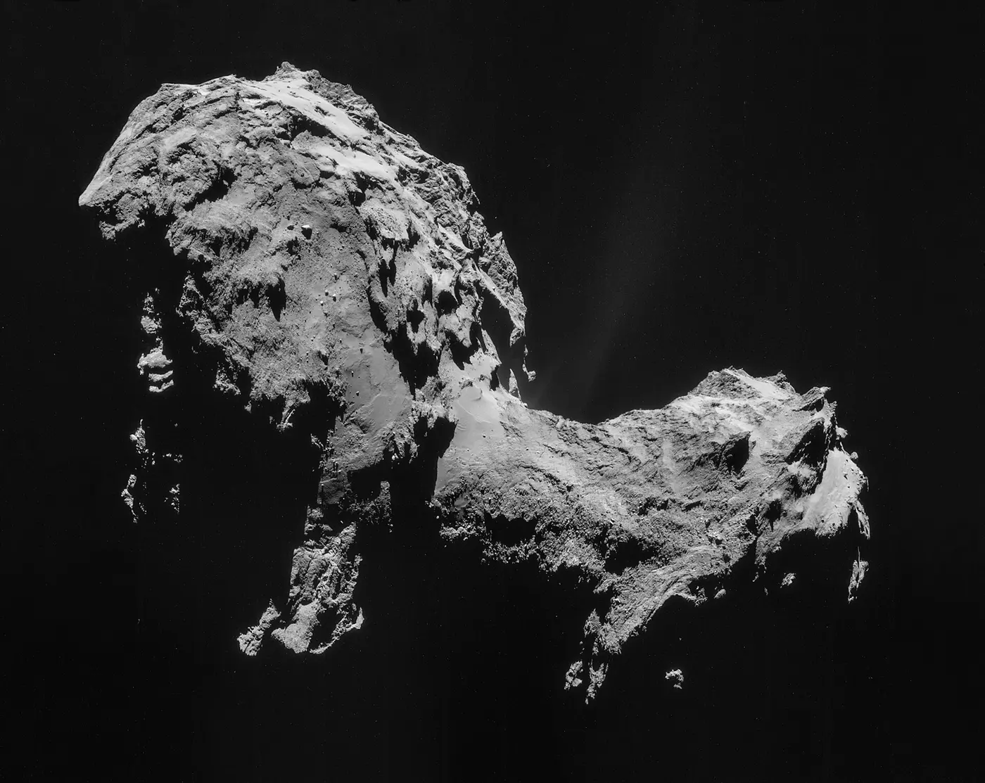 The rugged gray nucleus of a comet, shaped like two lumps joined at a narrow neck