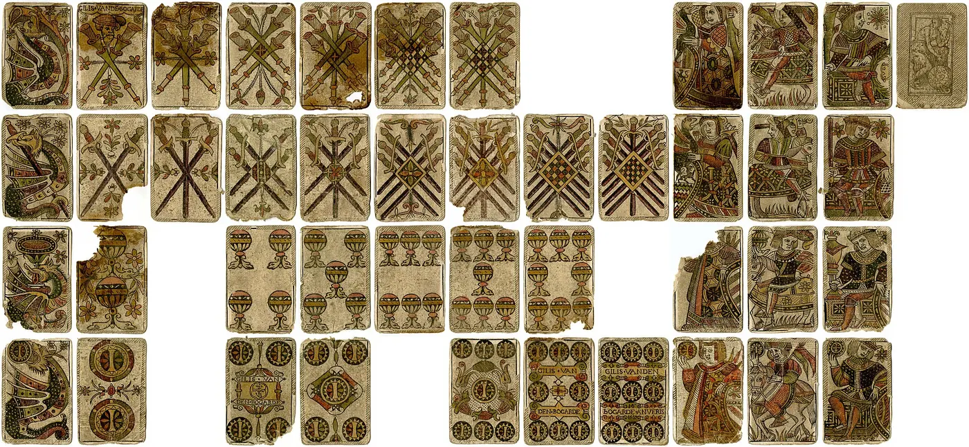 Old playing cards with clubs, swords, cups, coins and figures, sorted by suit