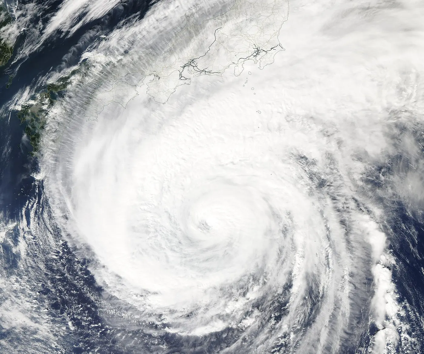 A satellite image of a huge spiral of white cloud over the ocean south of the Japanese archipelago