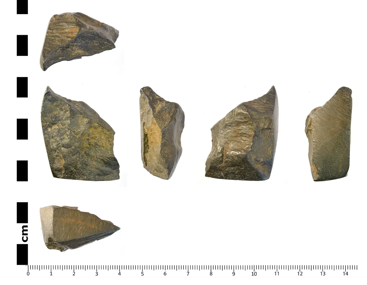 A dark, lustrous lump of graphite photographed from six directions, with a centimeter scale below