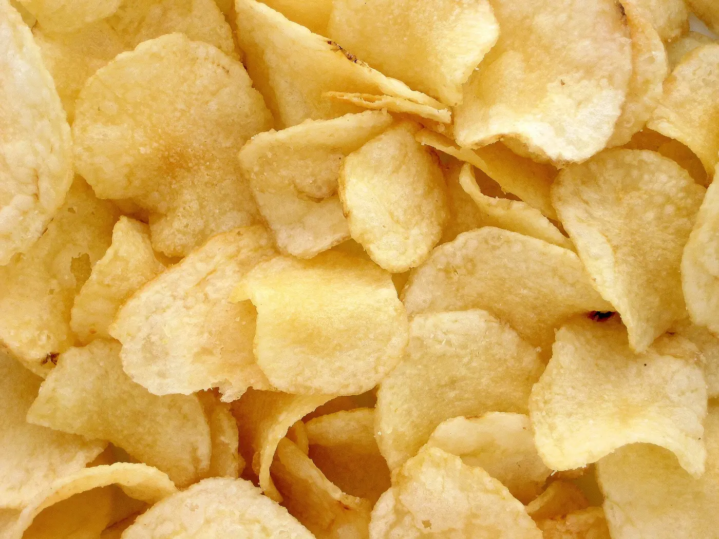 A frame filled with overlapping, golden fried potato chips