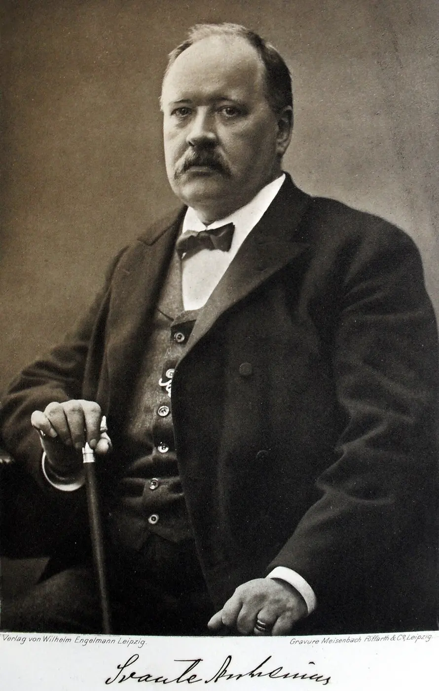 Black-and-white photograph of a mustached man seated with a cane in his hand