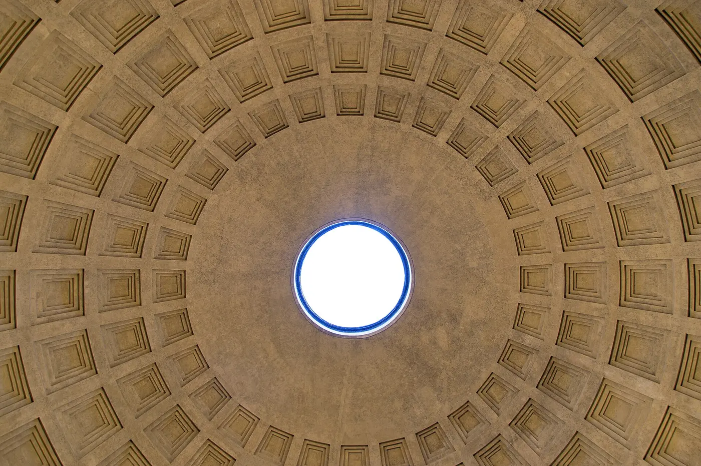 A huge dome lined with grid-like recessed panels, with a round opening at the top