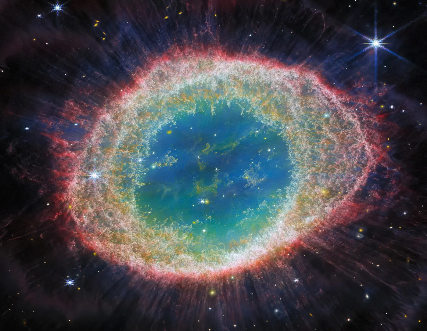 A nebula in which red and yellow gas spreads in an oval ring around a hollow center