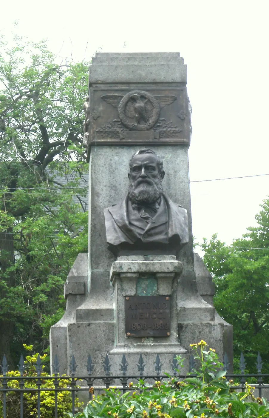 A bronze bust of a bearded man set into a stone monument