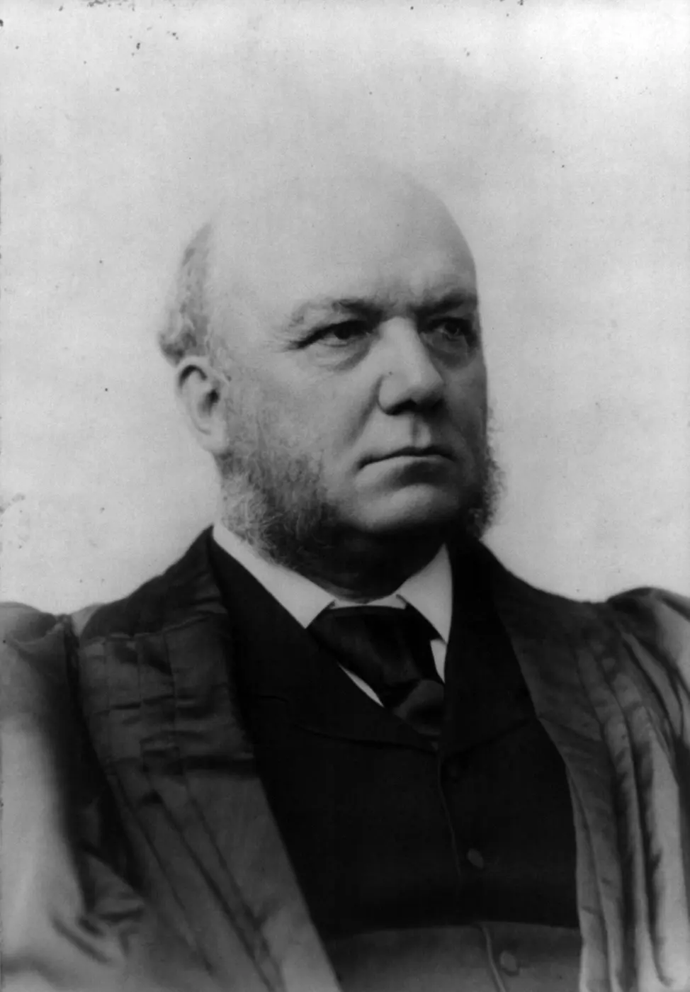 A black-and-white portrait of an elderly man in judicial robes with side-whiskers